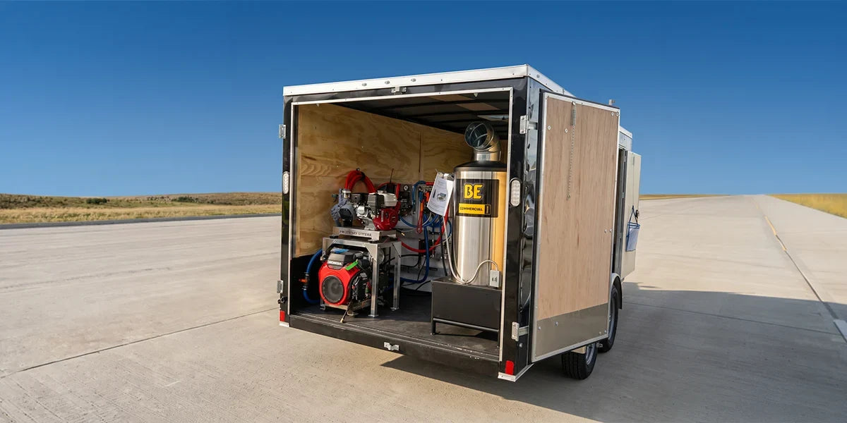 PEAK enclosed cleaning trailer with rear doors open, for illustration; final equipment configuration is described below.
